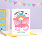 Load image into Gallery viewer, A cute and colourful card featuring an illustration of a butterfly and rainbow with the words &#39;happy birthday to a special granddaughter&#39; with space to personalise with a name and age.
