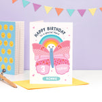 Load image into Gallery viewer, A cute and colourful card featuring an illustration of a butterfly and rainbow with the words &#39;happy birthday to a special niece&#39; with space to personalise with a name and age.
