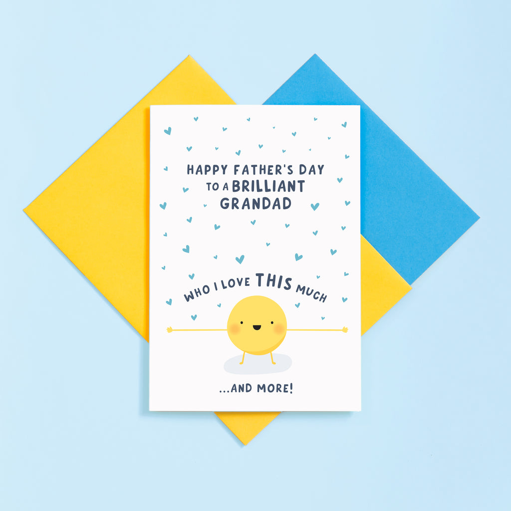 A cute card featuring a little sunshine character with outstretched arms and a collection of love hearts. The card reads Happy Father’s Day to a brilliant Grandad who I love this much and more.