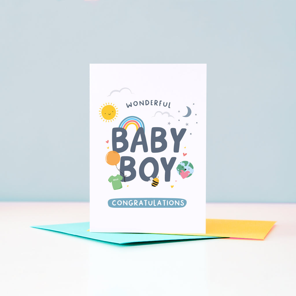 Wonderful Baby Boy Congratulations. A cute and colourful card featuring mini illustrations of a sunshine, rainbow, moon, stars, world holding a heart, balloon, tshirt and bee.
