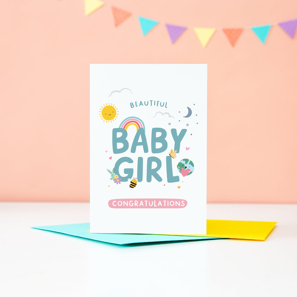 Beautiful Baby Girl Congratulations. A cute and colourful card featuring mini illustrations of a sunshine, rainbow, moon, stars, world holding a heart, balloon, tshirt and bee. 