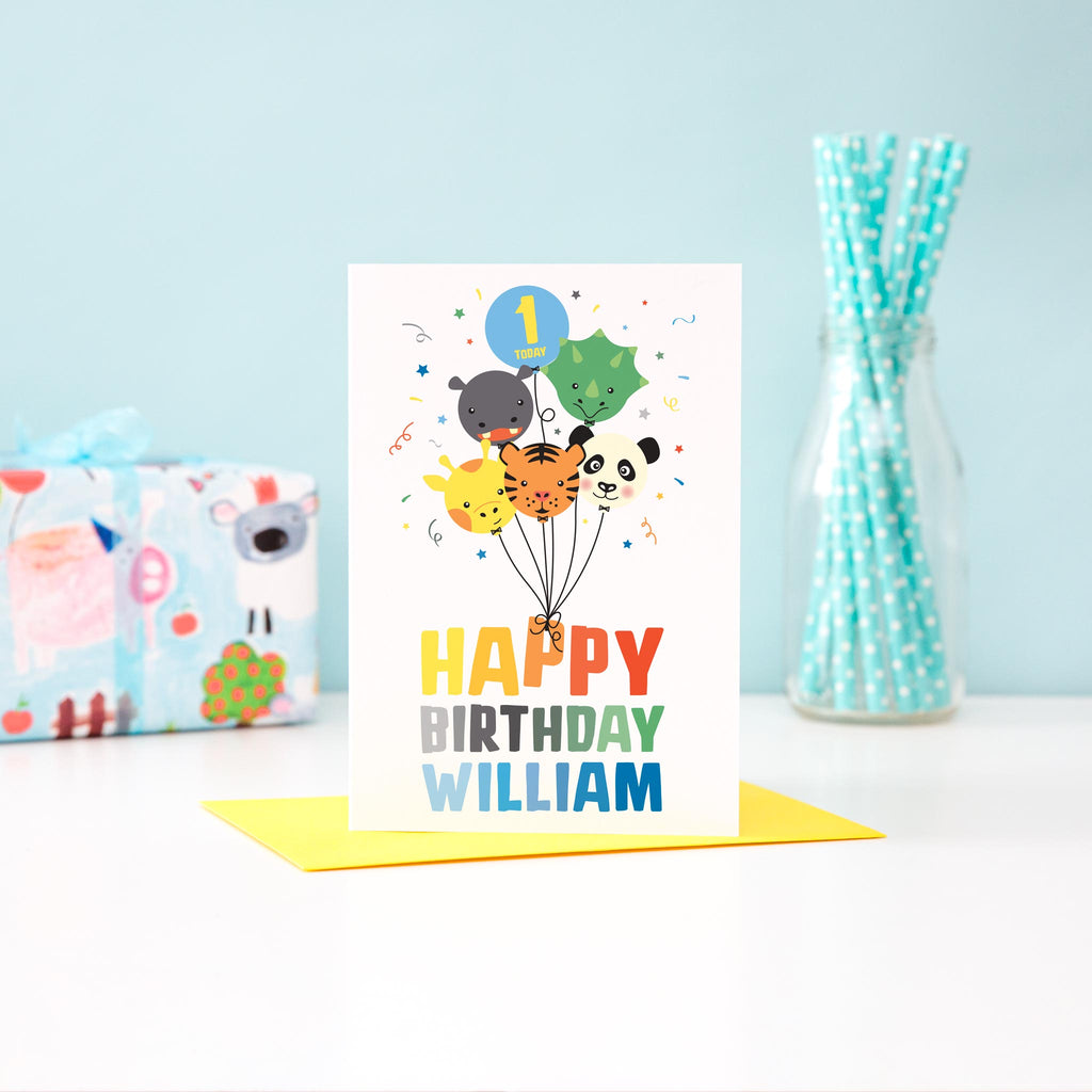 Boys happy birthday card in bright colours with a cute bunch of animal faced balloons including a giraffe, tiger, panda, hippo and dinosaur. The card includes personalised name and age.