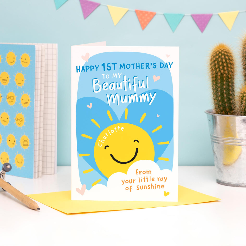Happy first Mother's day to my beautiful Mummy. A cute personalised card with smiling sunshine and love hearts. The card is personalised to include the name of the child on the sun.