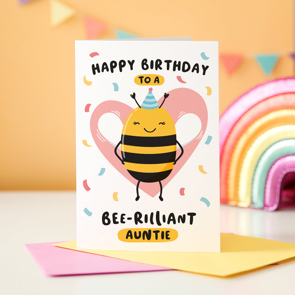 Happy birthday to a bee-rilliant Auntie. A cute and punny card featuring a happy bee wearing a party hat to represent Auntie, with a pink heart in the background and a sprinkle of confetti.