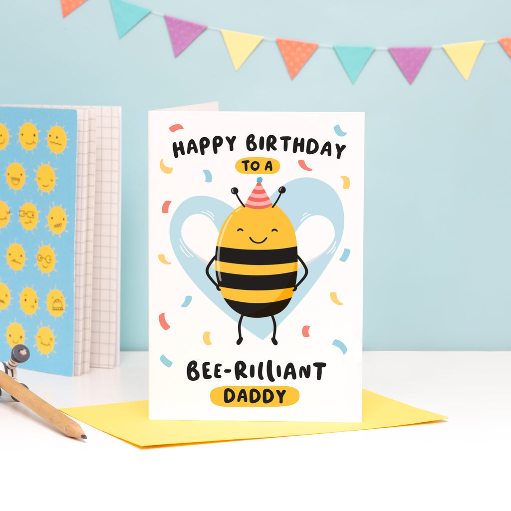Happy birthday to a bee-rilliant Daddy. A cute and punny card featuring a happy bee wearing a party hat to represent Daddy, with a light blue heart in the background and a sprinkle of confetti.