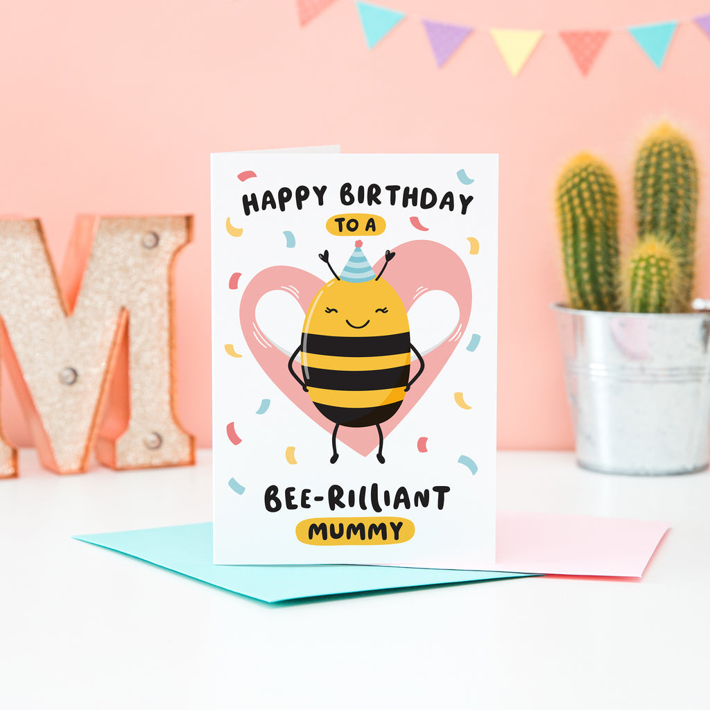 Happy birthday to a bee-rilliant mummy. A cute and punny card featuring a happy bee wearing a party hat to represent mummy, with a pink heart in the background and a sprinkle of confetti.
