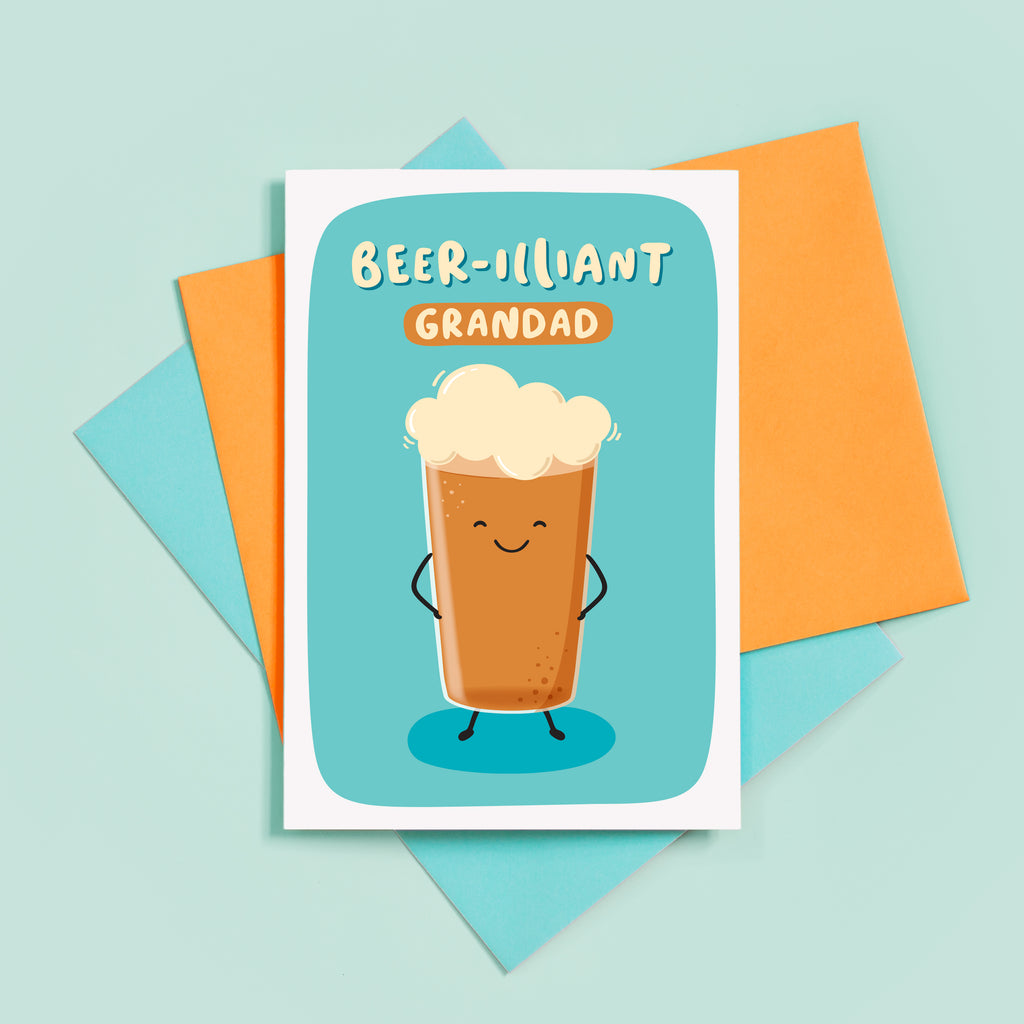 A funny card with a pun featuring a happy pint of beer and the words beer-illiant Grandad. The card has a bright turquoise background.