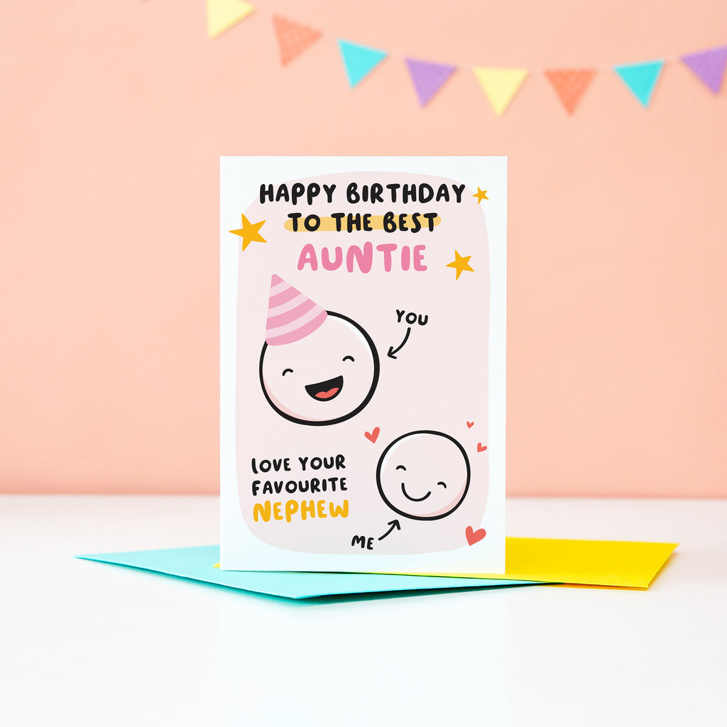 This card features two happy faces, one wearing a party hat representing Auntie and the other representing Nephew. The card reads 'happy birthday to the best Auntie, love your favourite Nephew'. It has a pale pink background with yellow stars and red hearts.