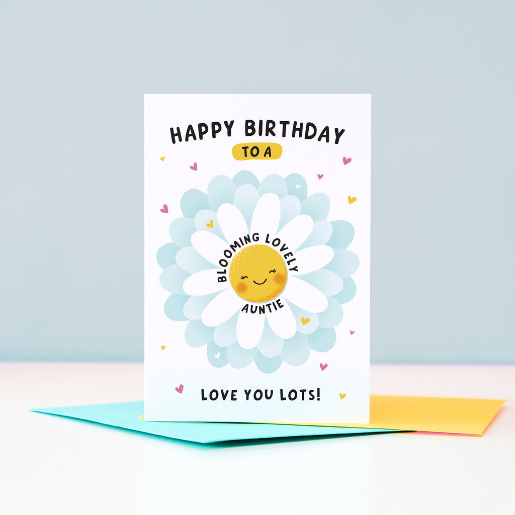Text on this card reads ‘Happy birthday to a blooming lovely Auntie, love you lots!’. A cute and punny card featuring a happy flower in full bloom to represent Auntie, with a collection of hearts.
