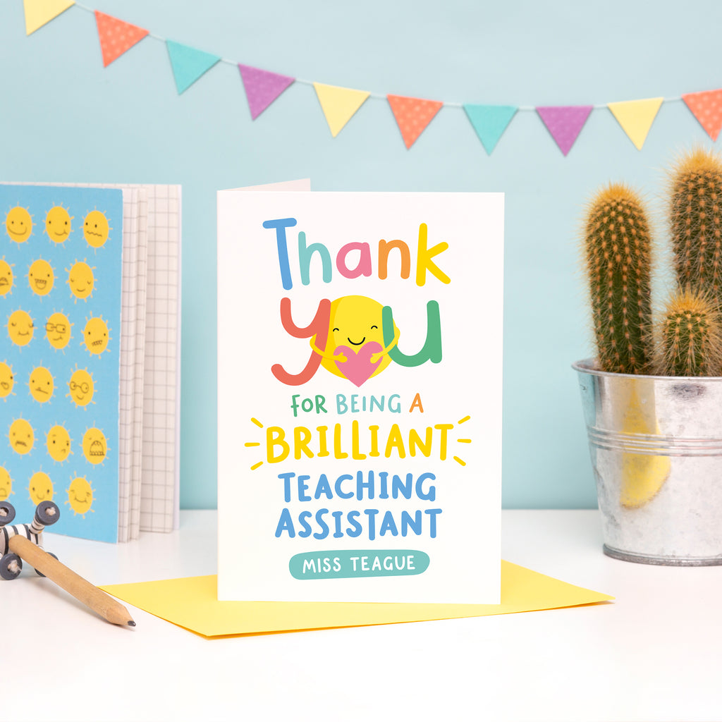 A bright and colourful card featuring hand lettering with the words, thank you for being a brilliant teaching assistant. There is space for personalising with the teaching assistants name.