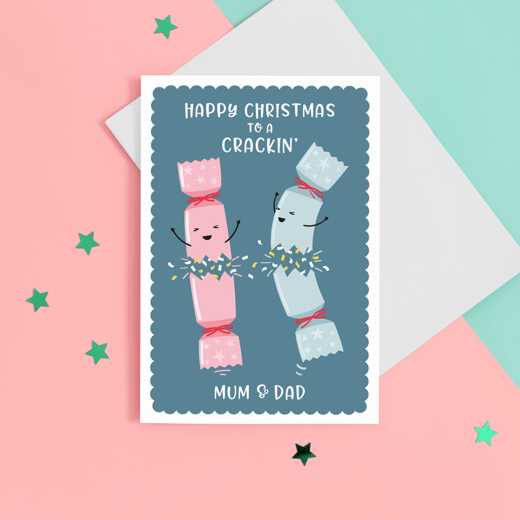 A funny Christmas card with a dark blue background, featuring two happy Christmas crackers and the words 'Happy Christmas to a crackin' Mum and Dad’. The card can be personalised with your parents preferred titles.