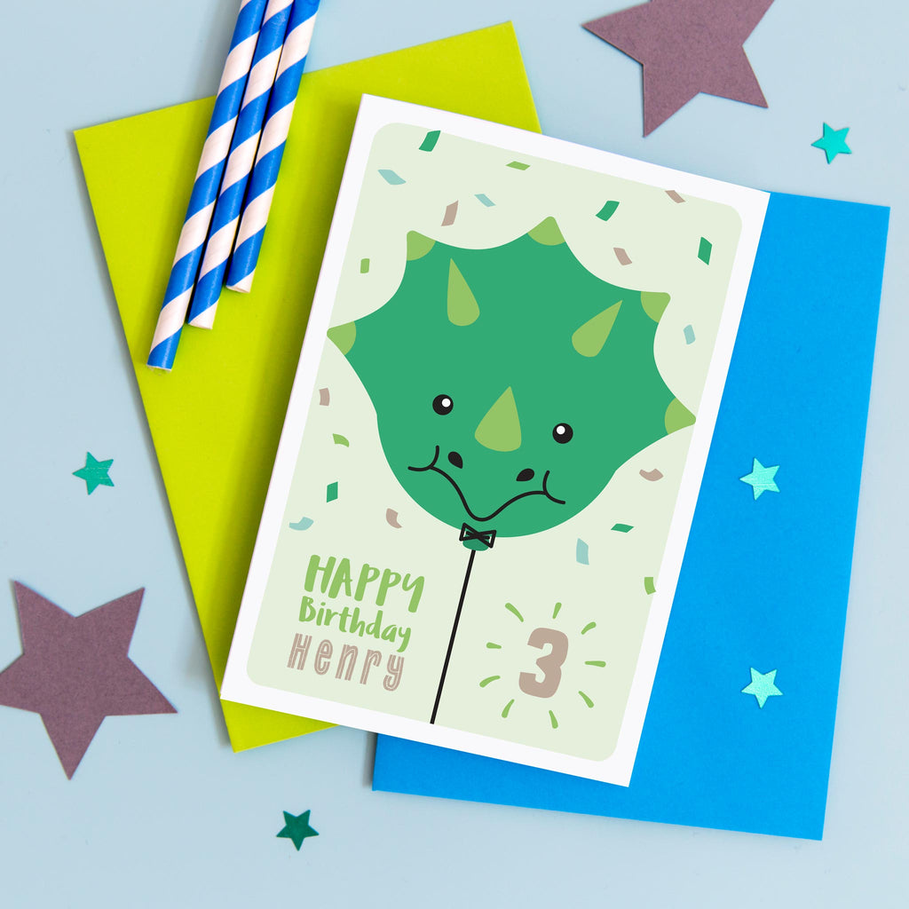 Happy birthday card with cute baby Triceratops face on a balloon and any personalised name and age.