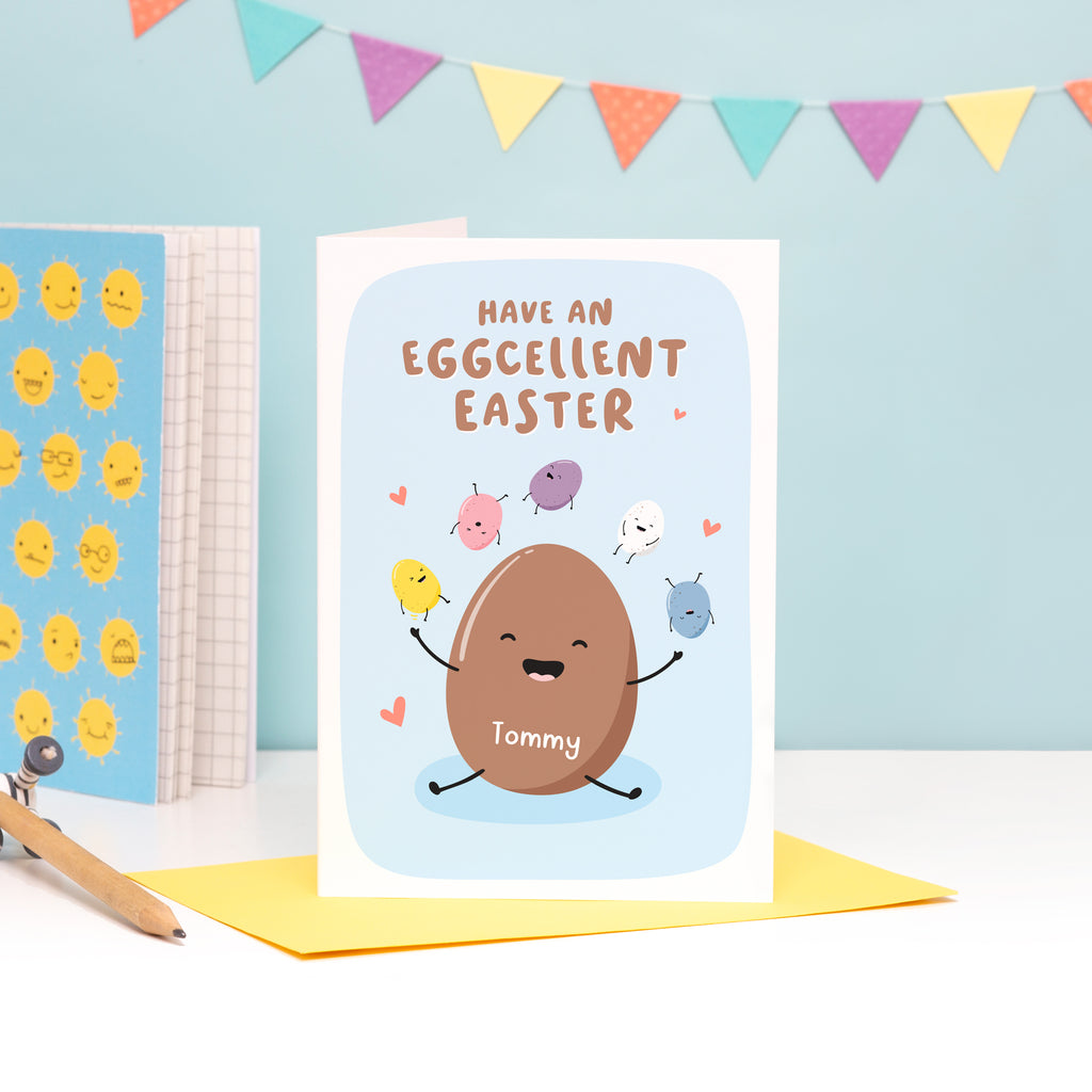 A funny Easter card which reads, 'have an excellent Easter'. The card features a happy chocolate Easter egg, juggling mini eggs and has space on the egg to personalise with a name.