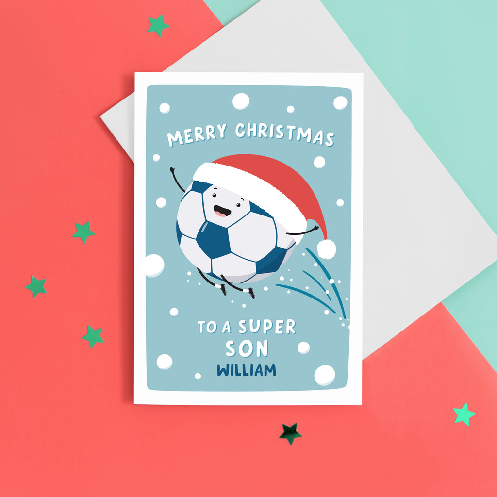A fun football themed Christmas card featuring a happy football wearing a santa’s hat on a snowy background. The card reads ‘Merry Christmas to a super Son’ with space underneath to personalise with a name.