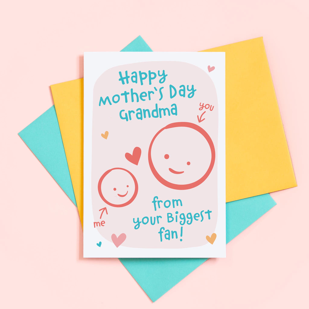 A cute Mother's day card for Grandma from her biggest fan. This card features a smiling face representing Grandma and a child’s face which can be personalised with a name. The background of the card is light pink and includes a collection of hearts around the design.