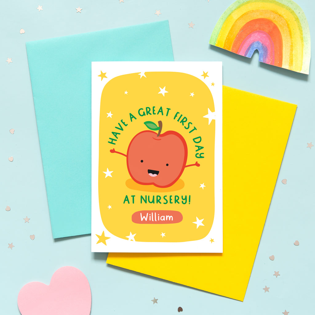 This card has a bright yellow background with white stars, and features a smiling happy apple with outstretched arms, and the words, 'Have a great first day at nursery'. There is a space underneath the text to personalise the card with the reciepients name.