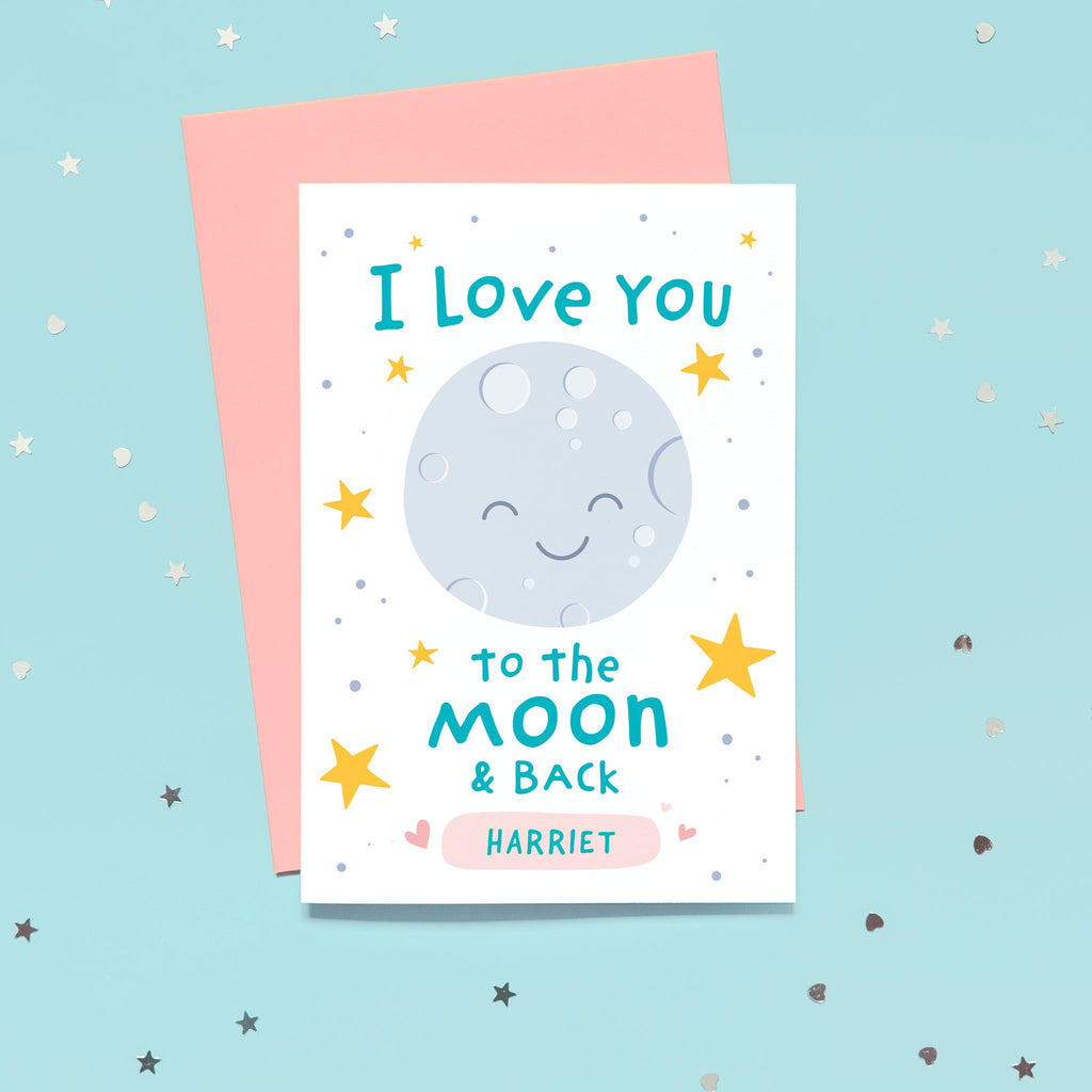 A happy card featuring smiley moon, a collection of yellow stars and the words I love you to the moon and back. The card has a pink rounded rectangular shape at the bottom for you to personalise with one or more names.