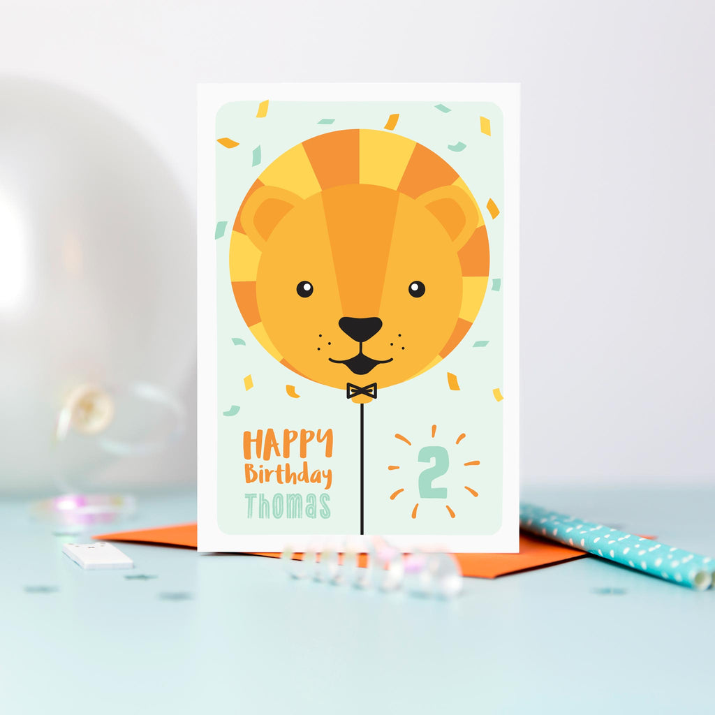 Happy birthday card with cute baby lion face on a balloon and any personalised name and age.