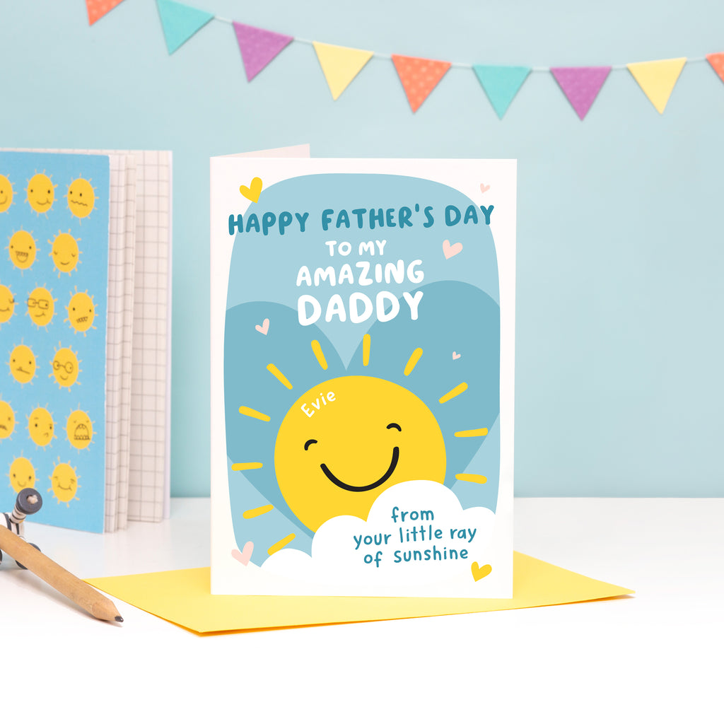 Happy Father's day to my amazing Daddy from your little ray of sunshine. A cute and bright personalised card with smiling sunshine and love hearts. The card can be personalised to include the name of the child on the sun.
