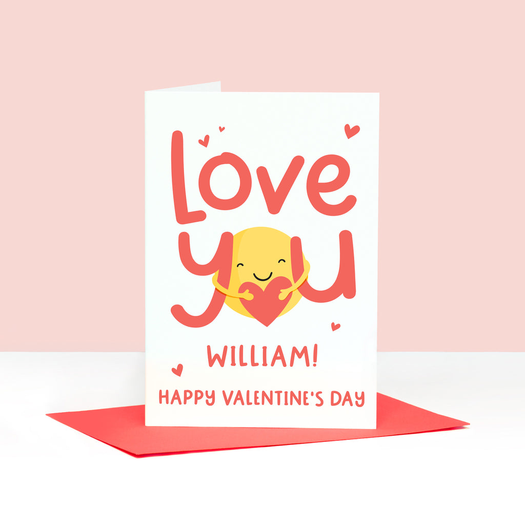 A super cute valentines card with the words 'love you' in red and featuring a sunshine hug holding a heart. This card can be personalised with a name.