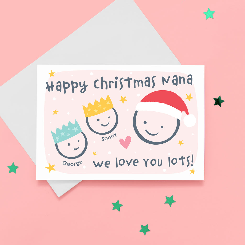 Happy Christmas Nana, we love you lots. Cute Christmas card featuring 3 faces representing Grandmother and 2 grandchildren. The smaller faces wear Christmas party hats and the larger face a santa hat. The card is personalised with the children's names and has a soft pink background.
