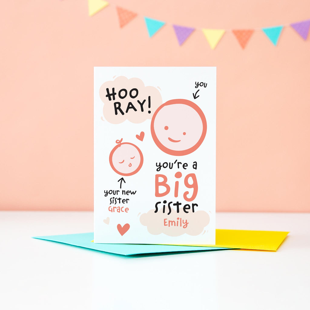 Hooray, you're a new big sister. Personalised card to congratulate someone on becoming a new big sister to a baby sister. The card features two smiling faces to represent each girl.