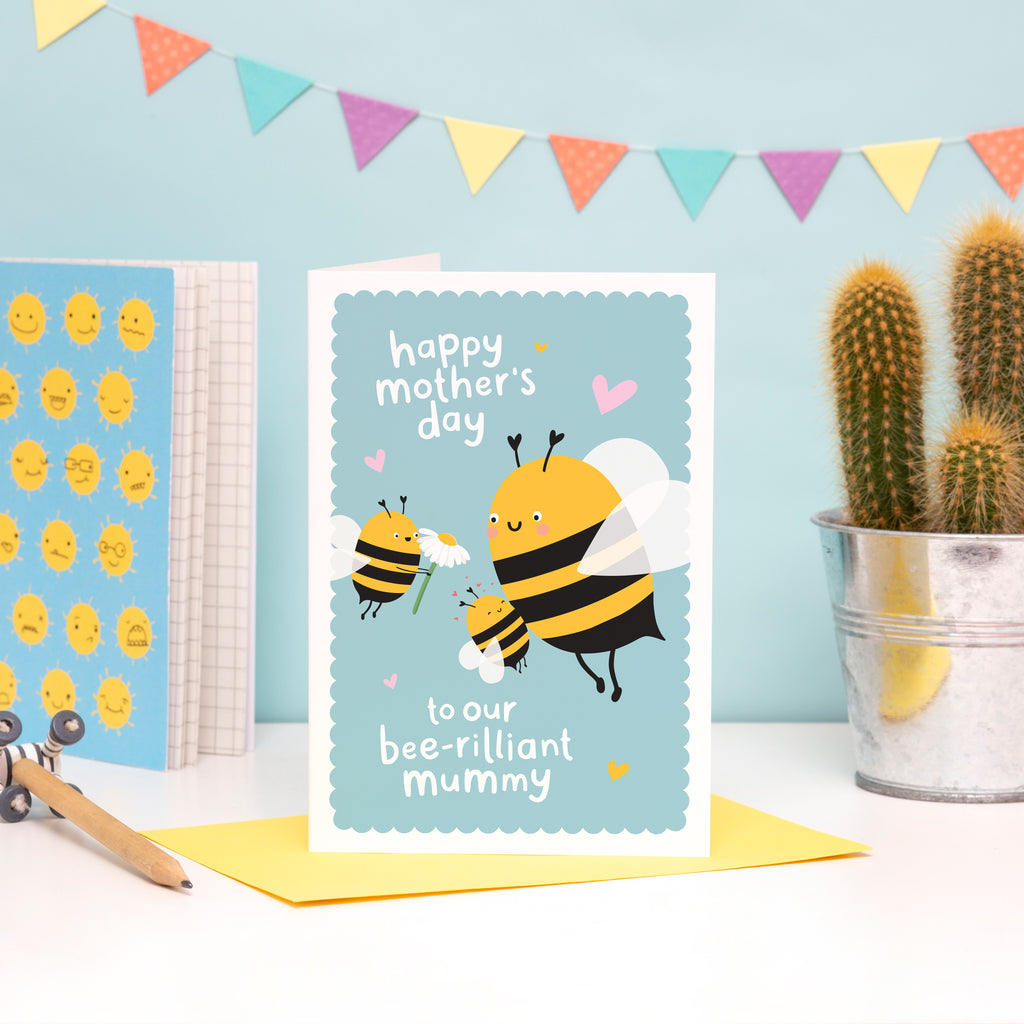 Happy Mother’s Day to our bee-rilliant Mummy. A cute and colourful card featuring a mummy bee and two little bees representing children. The card has a turquoise background and features little hand drawn love hearts.