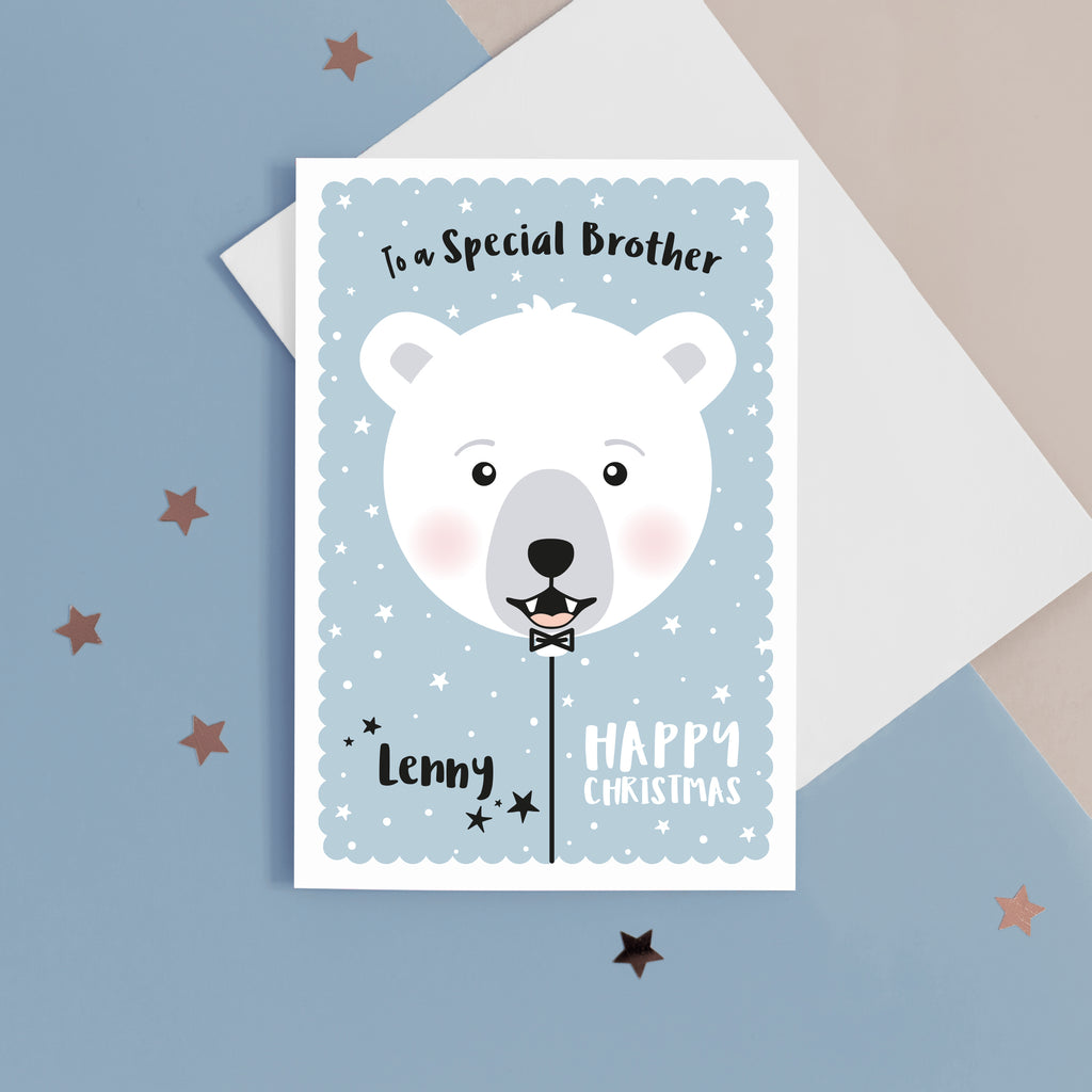 Happy Christmas to a special Brother. A cute personalised Christmas card featuring a smiling polar bear balloon in snow and stars. Add any name and personal greeting to this card.