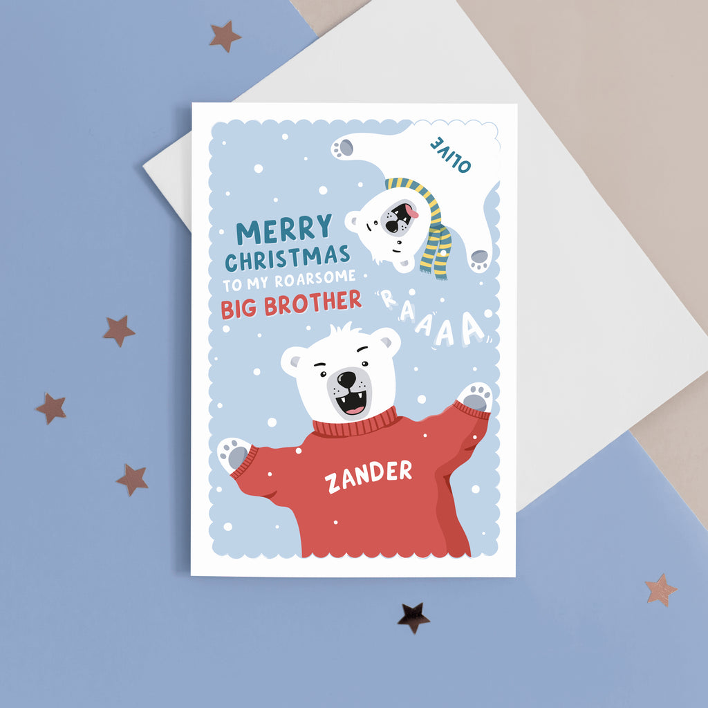 A fun Christmas card featuring two polar bears on a blue snowy background. The card reads ‘Merry Christmas to my roarsome big Brother’. The polar bears can be personalised with names to represent siblings. 