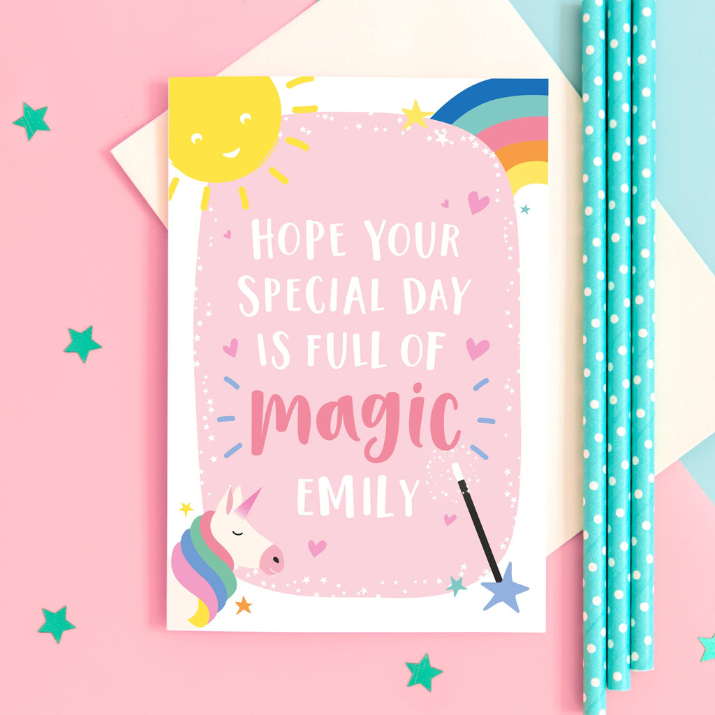 Hope your day is full of magic. name personalised birthday card featuring a unicorn and rainbow with smiling sun, magic wand and love hearts. birthday card for girls