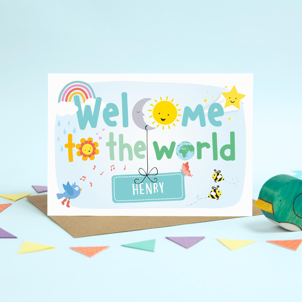 cute, colourful new baby card with rainbows, clouds, sun moon and stars. Also includes flowers, birds, bees and butterflies. This card is personalised with the new babies name hanging from the moon. text reads welcome to the world.