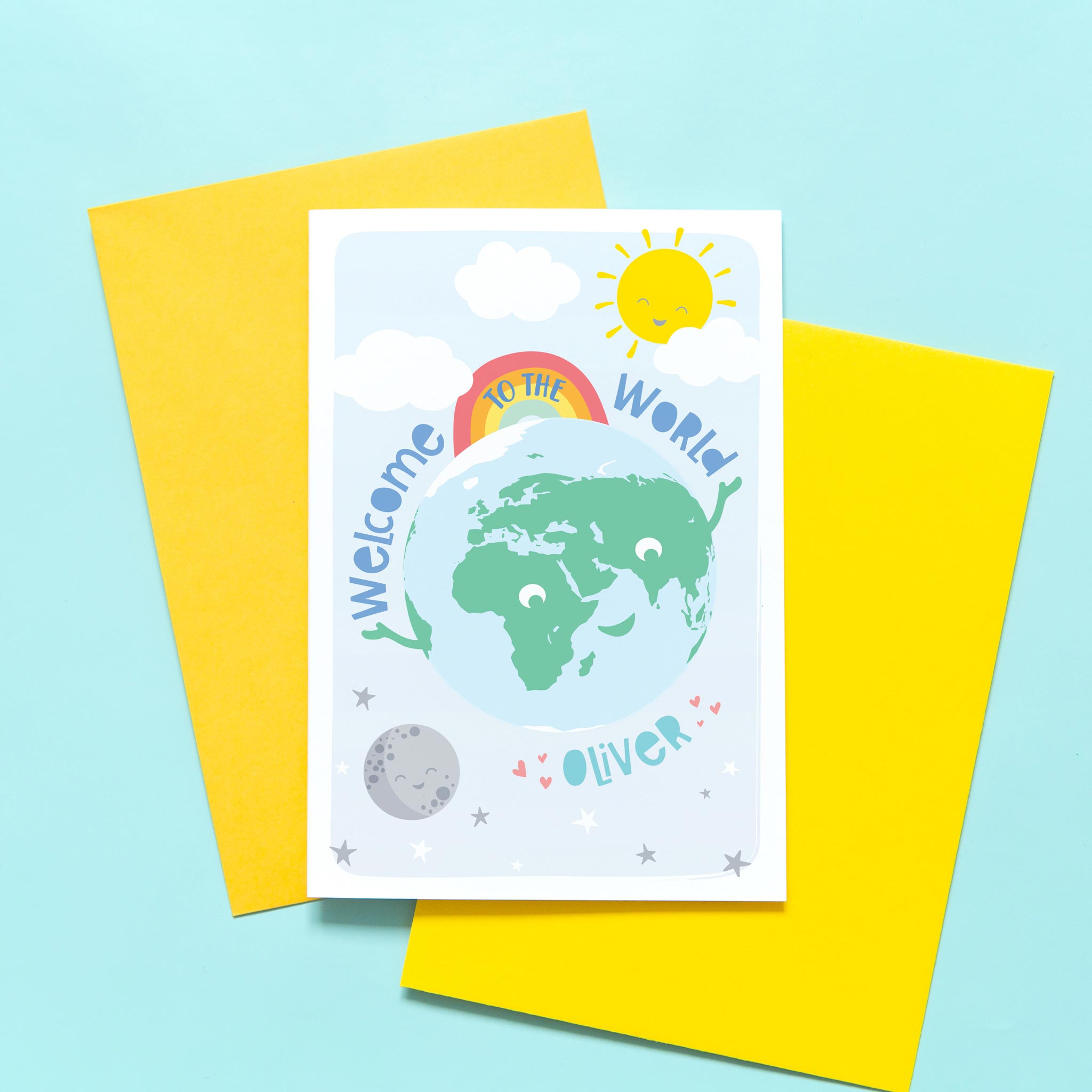 Greetings card with smiling earth character plus sun, moon and rainbow. text says welcome to the world and includes any personalised name in turquoise