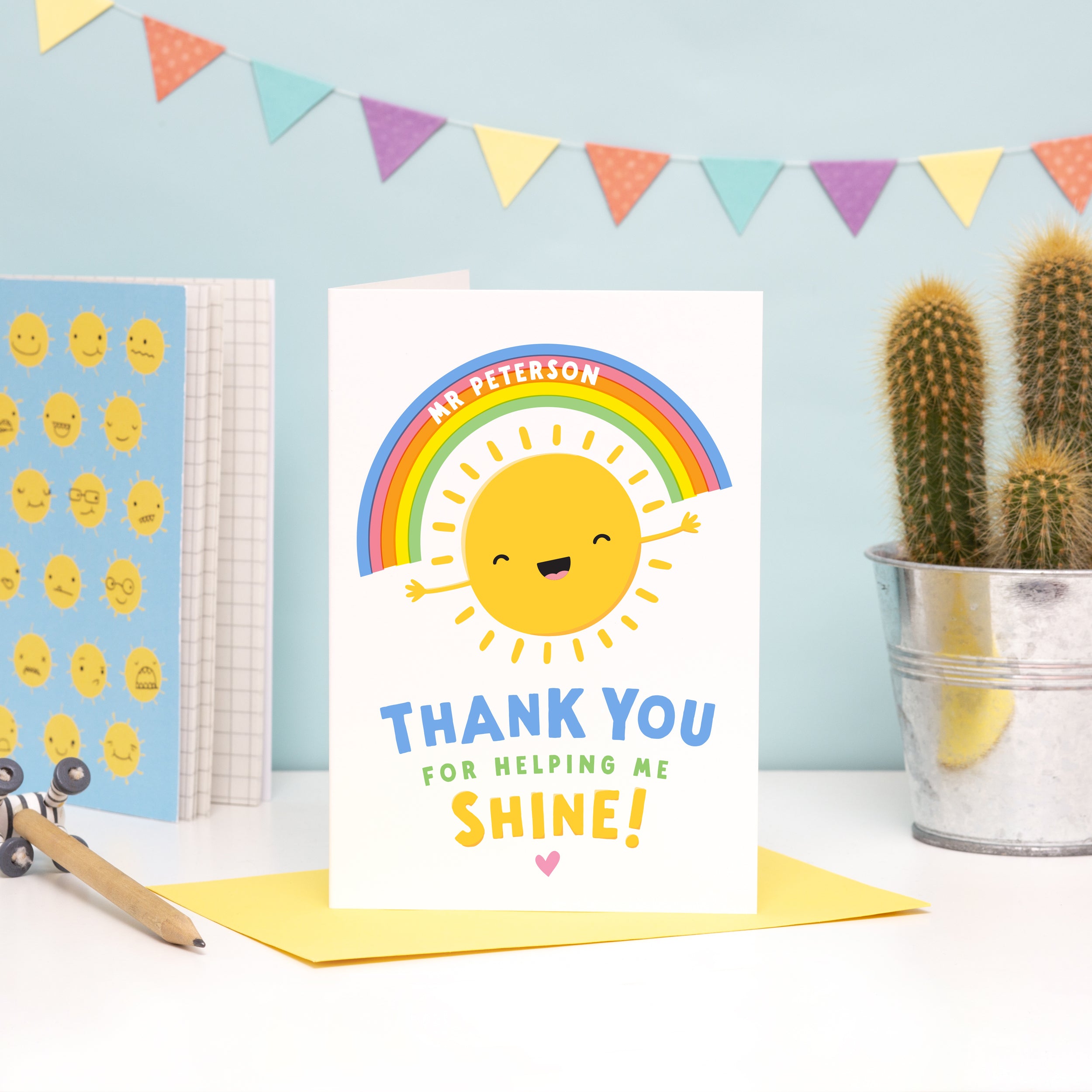 A fun and colourful card featuring a happy sunshine and rainbow with the words 'thank you for helping me shine'. The card can be personalised with the teacher / teaching assistants name on the rainbow.