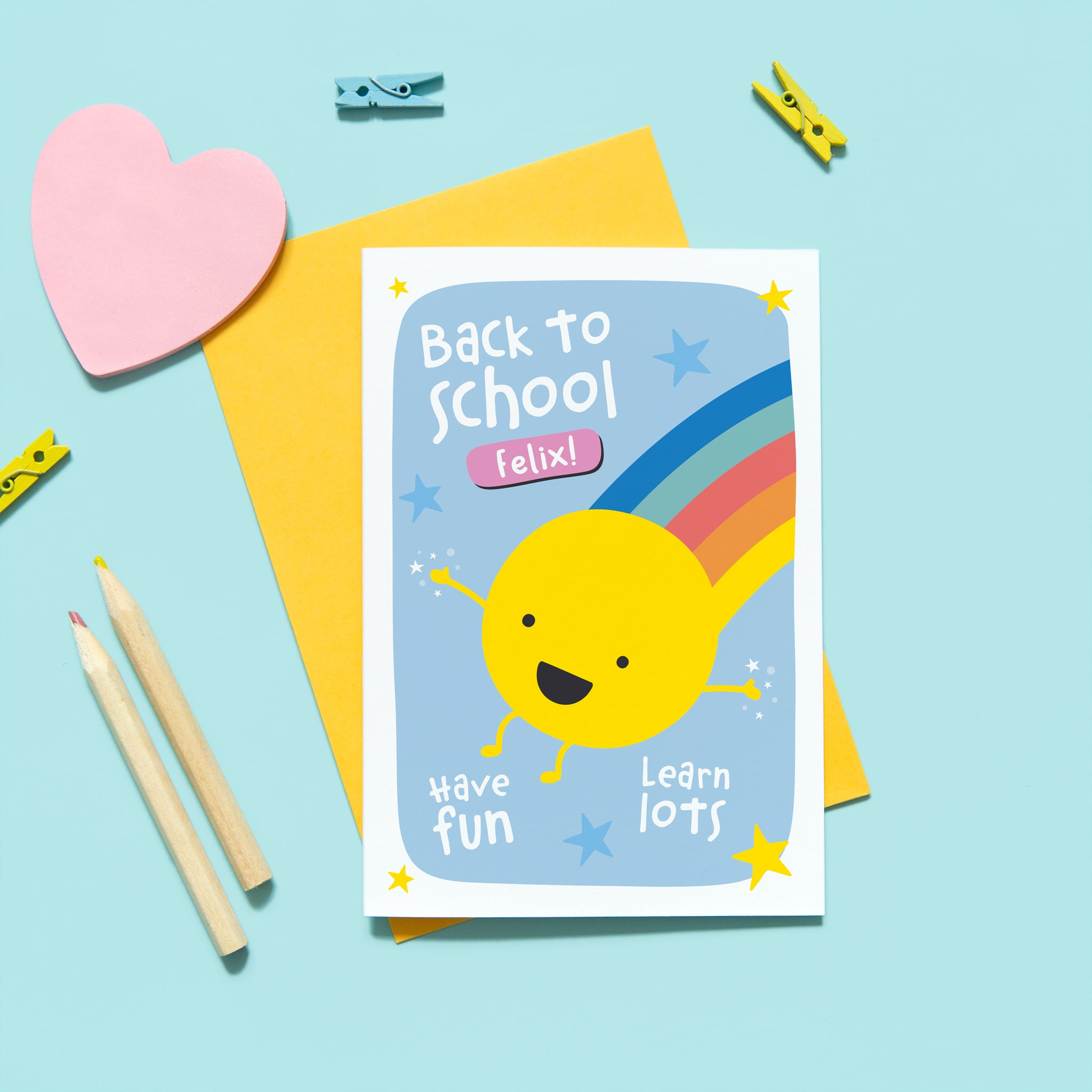 colourful back to school card with smiley face and rainbow design. Personalised with any name or word. Includes message to have fun and learn lots. Shown with personalised name.