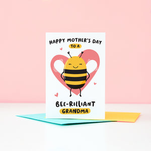 Happy mother’s day  to a bee-rilliant Grandma. A cute and punny card featuring a happy bee to represent Grandma, with a pink heart in the background and a collection of small hearts.