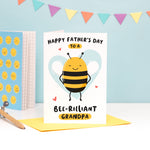 Load image into Gallery viewer, Happy Father&#39;s Day to a bee-rilliant Grandpa. A cute and punny card featuring a happy bee to represent Grandpa, with a light blue heart in the background.
