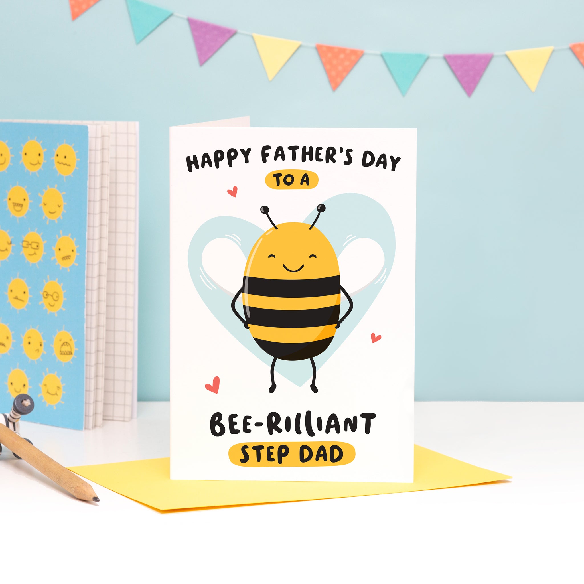 Happy Father's Day to a bee-rilliant Step Dad. A cute and punny card featuring a happy bee to represent Daddy, with a light blue heart in the background.