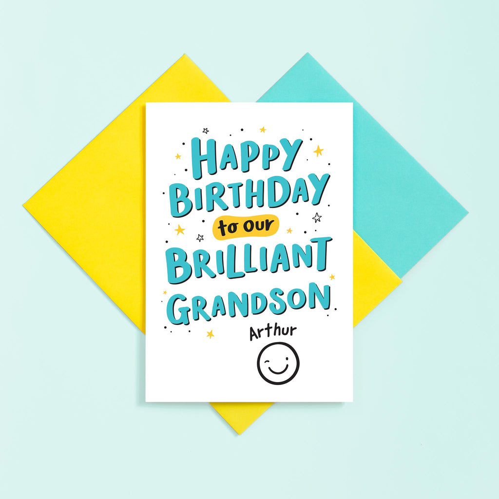 A hand lettered typographic card for a brilliant Grandson. The card features a collection of stars around the text and can be personalised with a name above a winking smiley face.