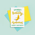 Load image into Gallery viewer, A bright and happy Birthday card featuring a dancing banana with a silly face and the words Grandpa, you&#39;re brilliantly bananas.
