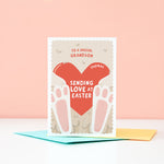 Load image into Gallery viewer, A cute Easter card featuring a fluffy bunny holding a red love heart. The card can be customised for any recipient and there is space on the love heart to include a name too.
