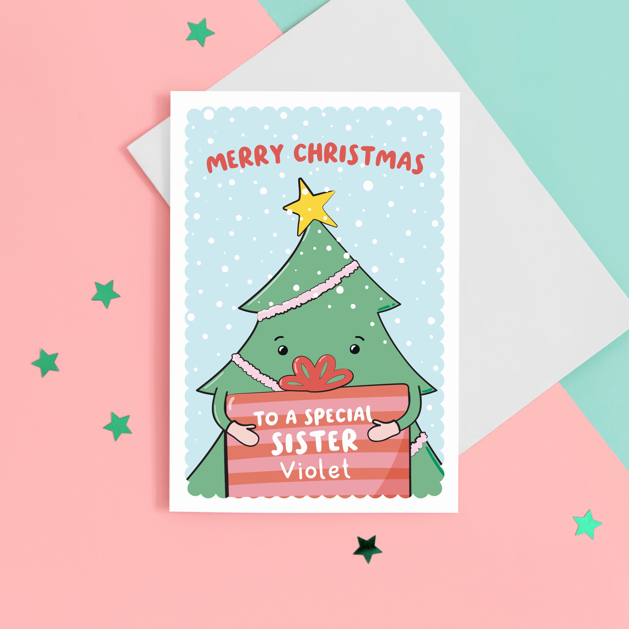 A cute Christmas card with a blue background, featuring a Christmas tree holding a present with a sprinkling of snow. The card reads Merry Christmas to a special Sister with space to personalise with a name.