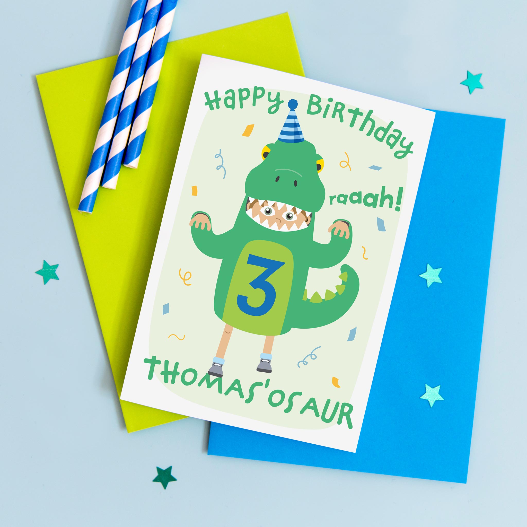 Birthday card with cute boy dressed in a dinosaur costume. Personalised for any name and age, as well age eye colour, skin colour and hair colour. Shown age three.