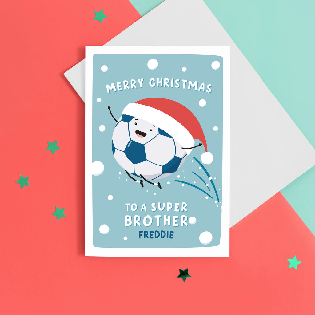 A fun football themed Christmas card featuring a happy football wearing a santa’s hat on a snowy background. The card reads ‘Merry Christmas to a super Brother’ with space underneath to personalise with a name.