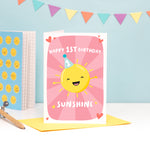 Load image into Gallery viewer, A colourful and fun design featuring a happy sunshine wearing a party hat with the number 1 on it. The card reads’ happy 1st birthday sunshine’ and you can add the childs name to the sunshine. The card has a colourful pink starburst background.
