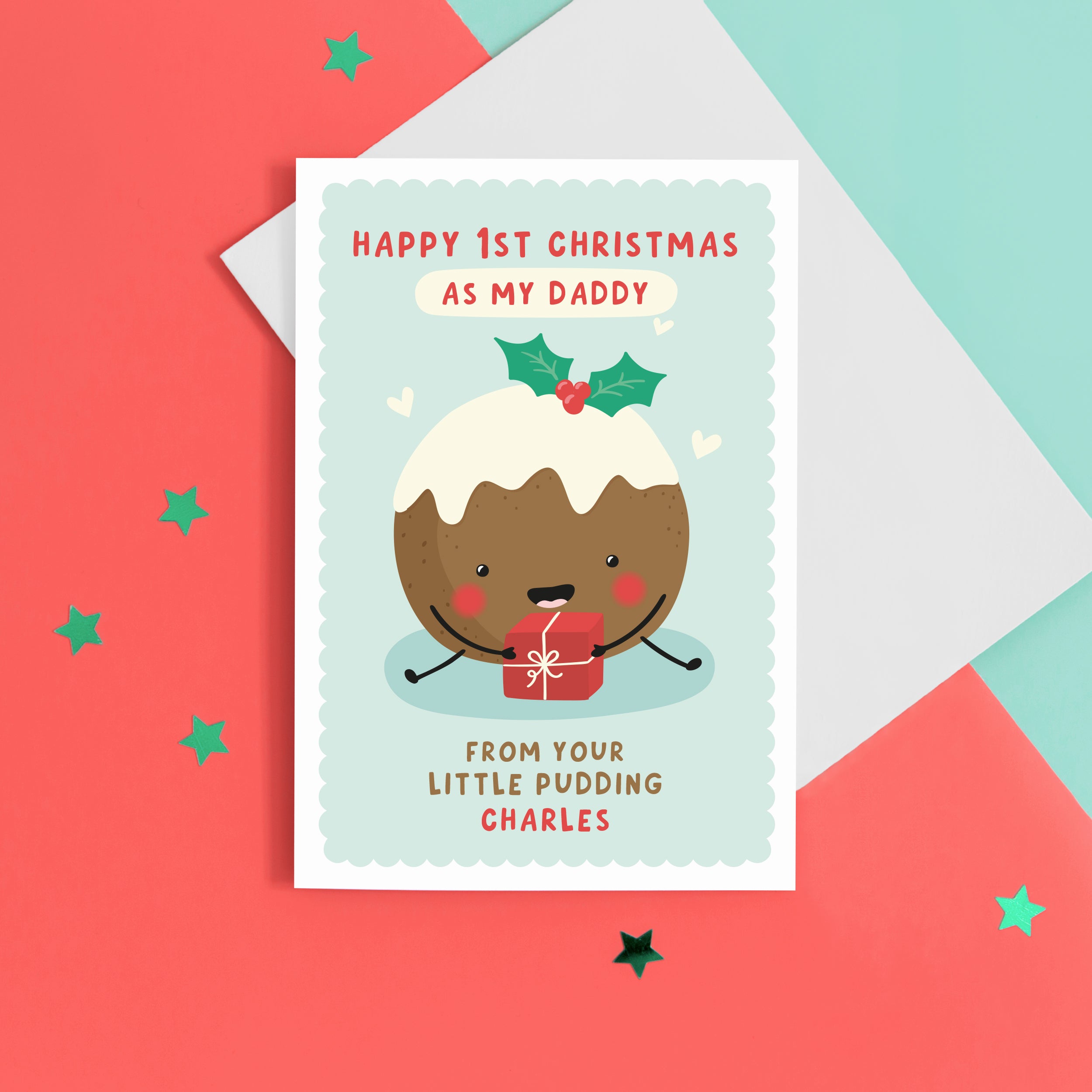 A super cute card featuring a happy little Christmas pudding illustration, holding a present. The card reads 'Happy 1st Christmas as my Daddy from your little pudding', with space to personalise with the baby's name.