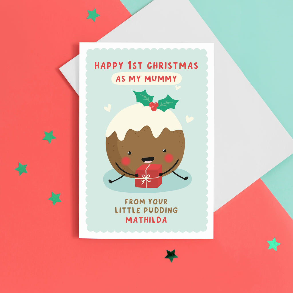 A super cute card featuring a happy little Christmas pudding illustration, holding a present. The card reads 'Happy 1st Christmas as my Mummy from your little pudding', with space to personalise with the baby's name.