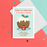 Load image into Gallery viewer, A super cute card featuring a happy little Christmas pudding illustration, holding a present. The card reads &#39;Happy 1st Christmas as my Nana and Grandad from your little pudding&#39;, with space to personalise with the baby&#39;s name.
