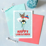 Load image into Gallery viewer, Happy Christmas. A cute Christmas card featuring a collection of balloon characters - polar bear, penguin, snowman and red nosed reindeer. Set against a turquoise background and red text.
