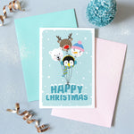 Load image into Gallery viewer, Happy Christmas. A cute Christmas card featuring a collection of balloon characters - polar bear, penguin, snowman and red nosed reindeer. Set against a turquoise background and text.
