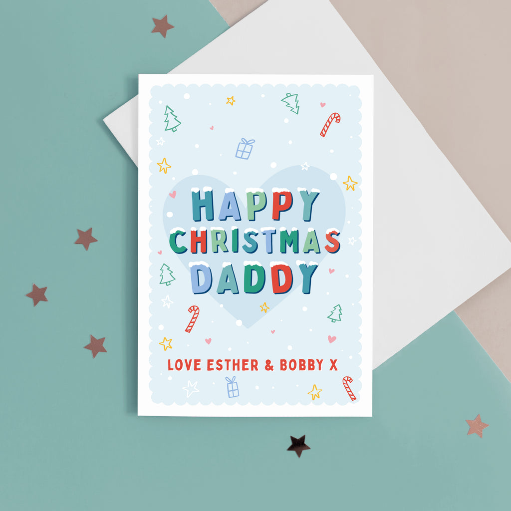 A sweet Christmas card with a light blue background and small hand drawn illustrations of Christmas trees, presents, stars and hearts. The card has snow topped wording in festive colours which reads 'Happy Christmas Daddy'. The bottom of the card can be customised with your own message.